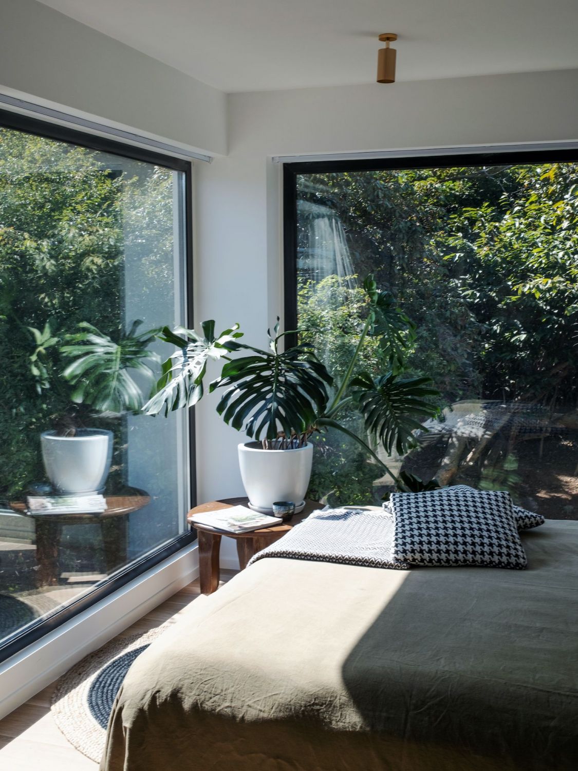 The master bedroom features large windows that face the greenery (Photo: Abram Deyo)