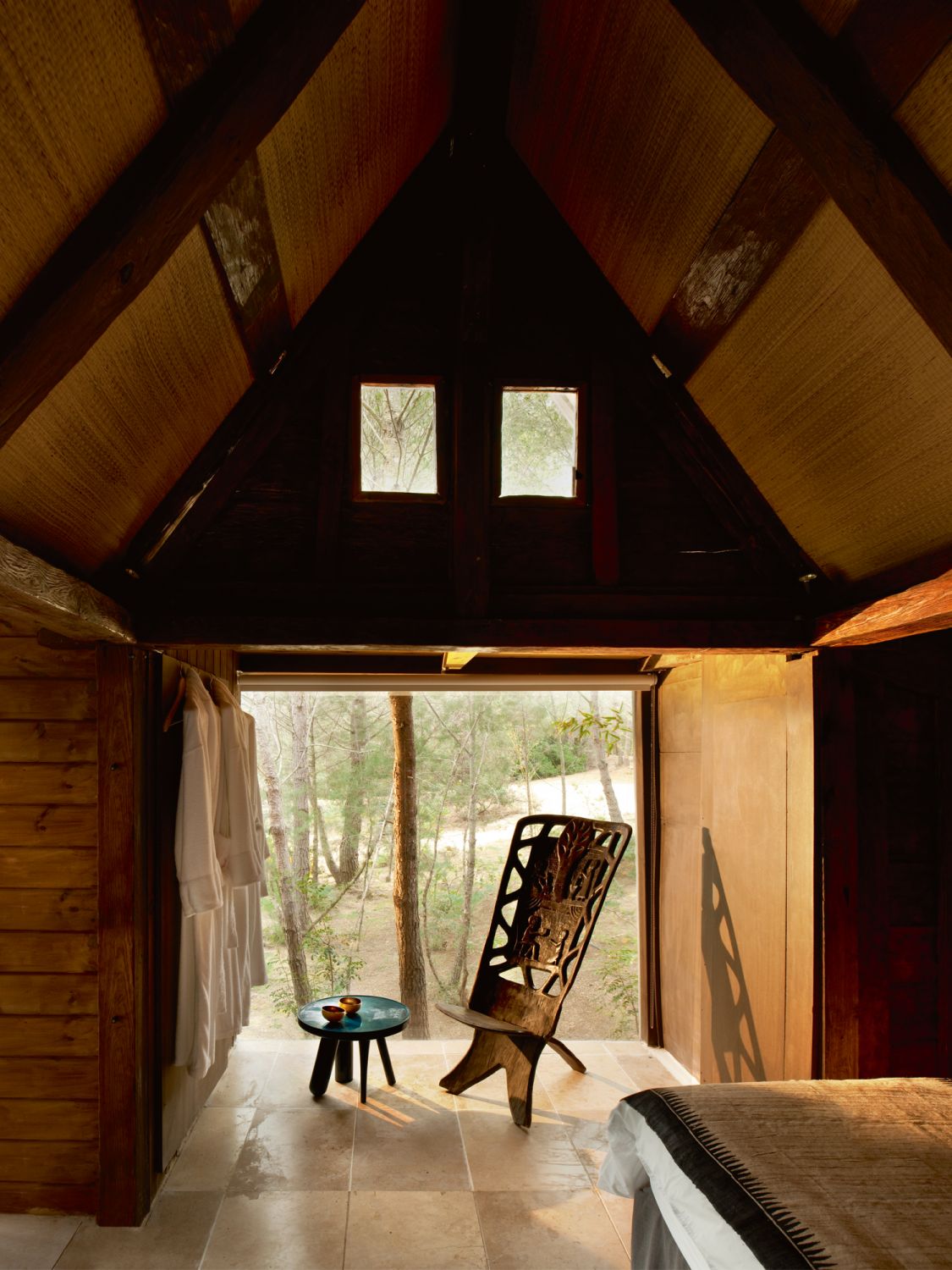 Wooden accents and traditional furnishings bring a rustic charm to this Bali-style cabin