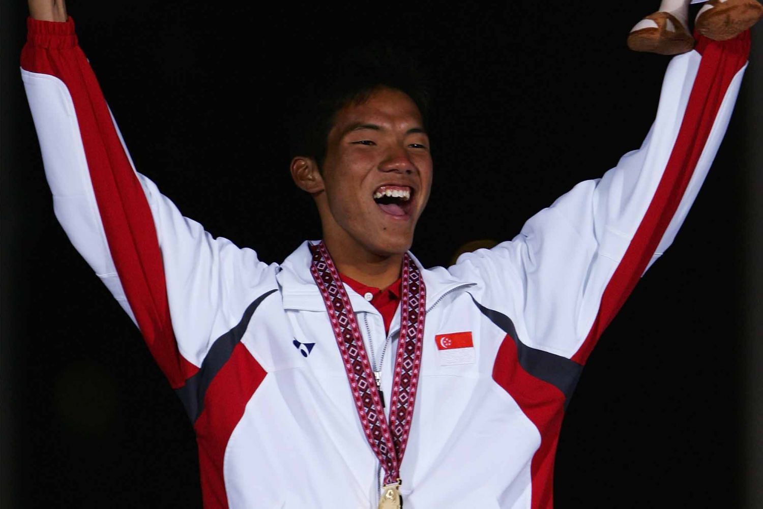 Gold medallist Soh Khyan Tat Maximilian of Singapore celebrates after winning the Mens Laser Class during the 15th Asian Games Doha 2006. (Photo: Getty Images)