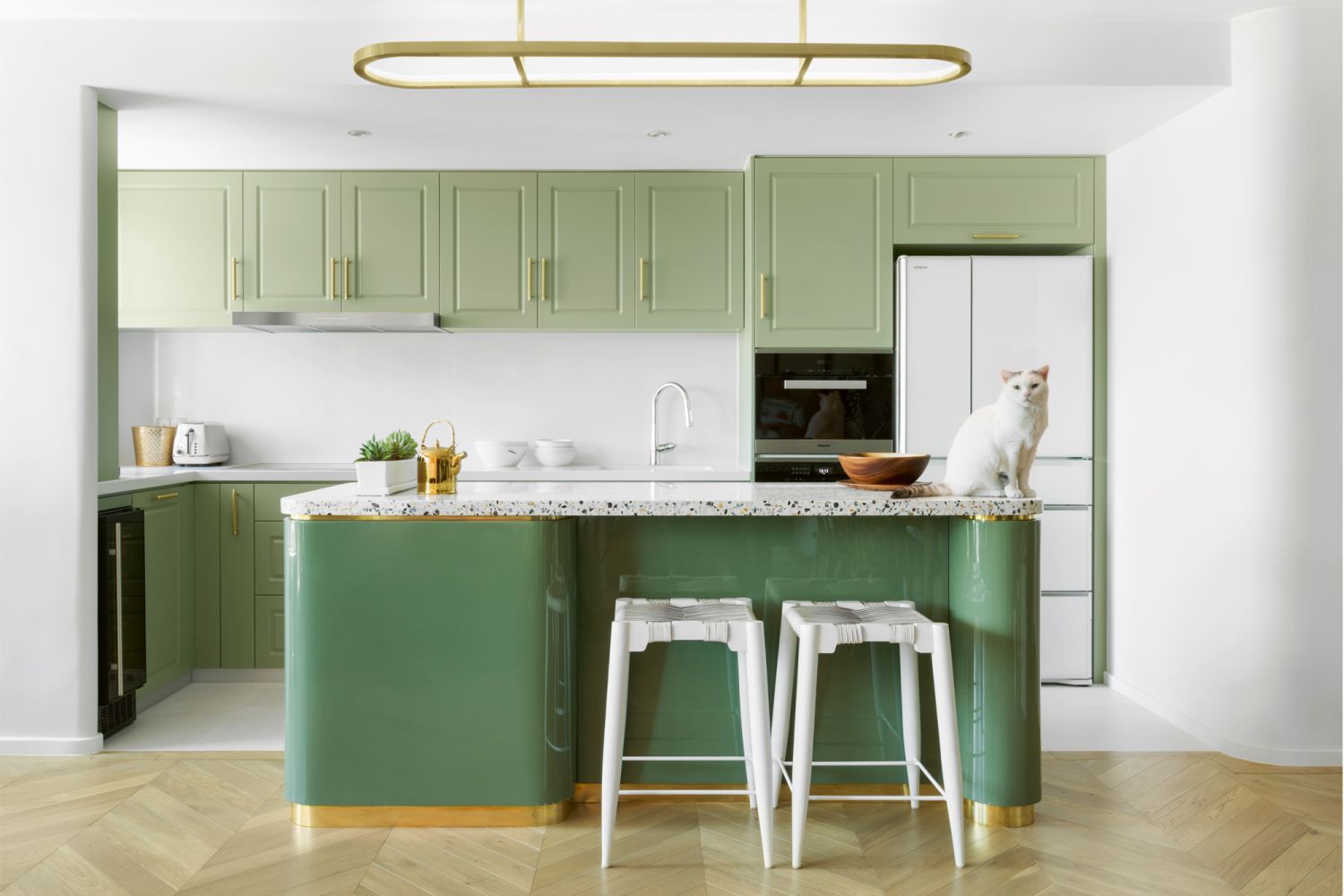 A kitchen with green lacquered cabinetry, designed by JJ Acuna / Bespoke Studio