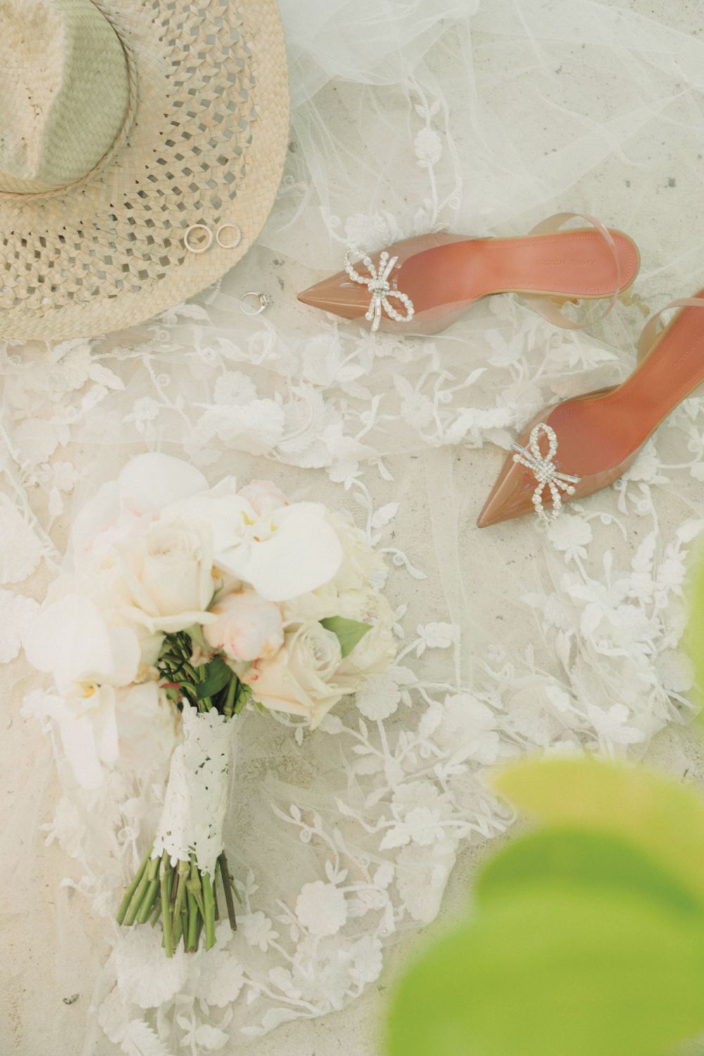 Wedding bands from Tiffany & Co, bouquet of peonies and roses, crystal slingback pumps from Amina Muaddi and an intricate custom veil by Reem Acra