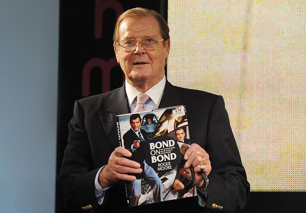 LONDON, UNITED KINGDOM - OCTOBER 22: Sir Roger Moore meets fans and signs copies of his book 'Bond on Bond' at HMV, Oxford Street on October 22, 2012 in London, England. (Photo by Stuart Wilson/Getty Images)