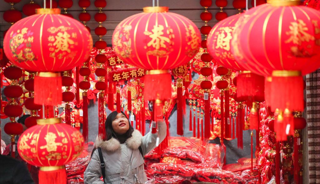 HUAI'AN, CHINA - DECEMBER 27, 2021 - Customers select New Year ornaments at huitong Wholesale market in Huai 'an, East China's Jiangsu Province, Dec. 27, 2021. Sales of Spring Festival couplets, New Year pictures, zodiac pendants, lanterns and other traditional New Year supplies in wholesale markets hit a peak. (Photo credit should read Zhao Qirui / Costfoto/Future Publishing via Getty Images)