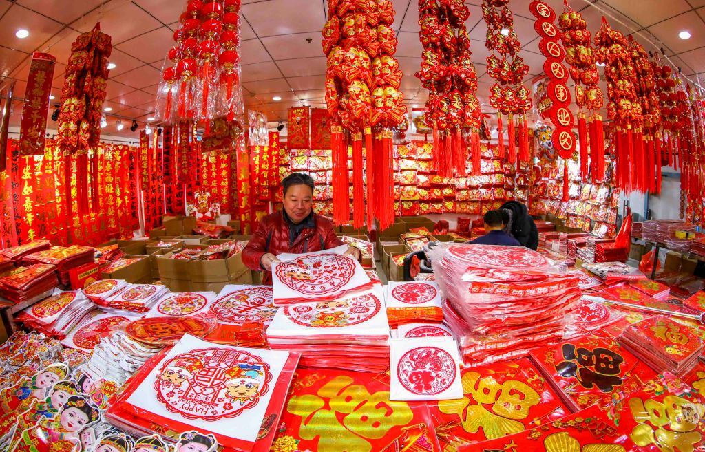 HUAI'AN, CHINA - DECEMBER 27, 2021 - Customers select New Year ornaments at huitong Wholesale market in Huai 'an, East China's Jiangsu Province, Dec. 27, 2021. Sales of Spring Festival couplets, New Year pictures, zodiac pendants, lanterns and other traditional New Year supplies in wholesale markets hit a peak. (Photo credit should read Zhao Qirui / Costfoto/Future Publishing via Getty Images)