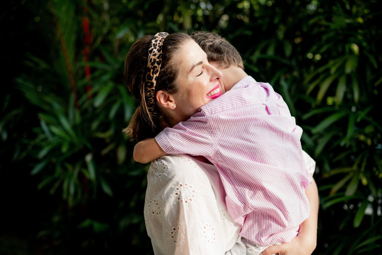 Mollie Jean de Dieu, founder of Emotional Inclusion, hugging her son Louis at the end of a work day