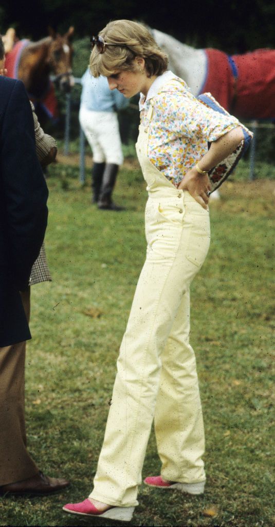 COWDRAY PARK, ENGLAND - JULY 12: Lady Diana Spencer, wearing yellow dungarees with a floral blouse and red wedges, attends a polo match at Cowdray Park Polo Club on July 12, 1981 in Gloucestershire, United Kingdom. (Photo by Anwar Hussein/WireImage)