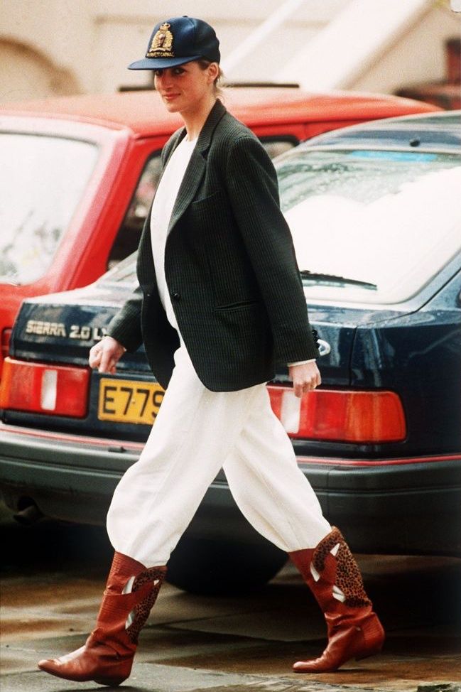 Princess Diana wearing an unusual combination of white trousers, boots, a blazer jacket and a baseball cap after taking her sons to school at Wetherby, 25th April 1989. (Photo by Daily Mirror/Mirrorpix/Getty Images)