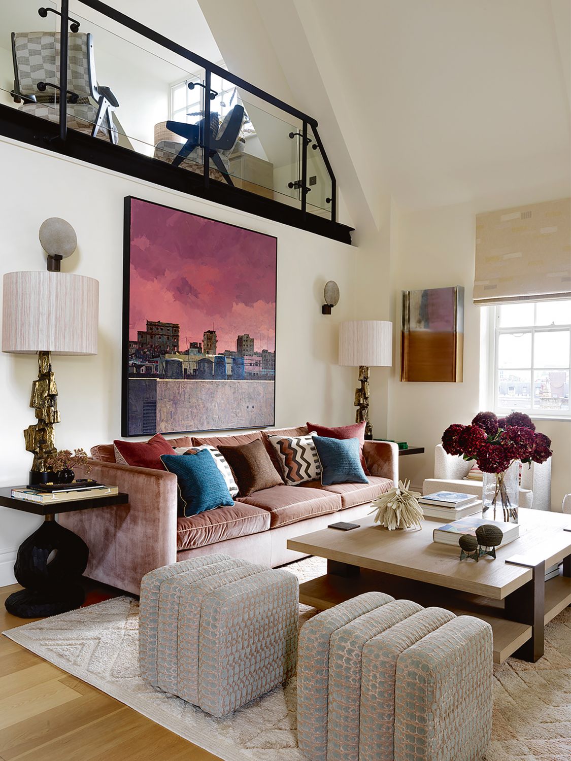 The blush pink tones on the sofa and accent cushions pick up the rosy hues on Cuban artist Gustavo Acosta’s painting, which depicts the skyline of Cuban capital Havana