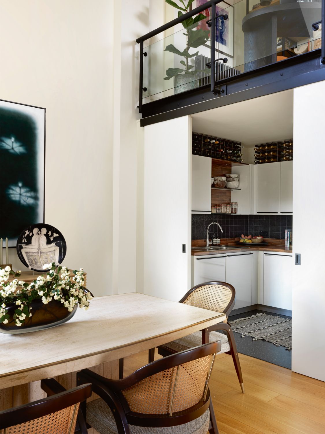 A work by Arturo Cuenca takes pride of place in the dining area, which also features a vintage dining table by Willy Rizzo sourced from a London antiques store