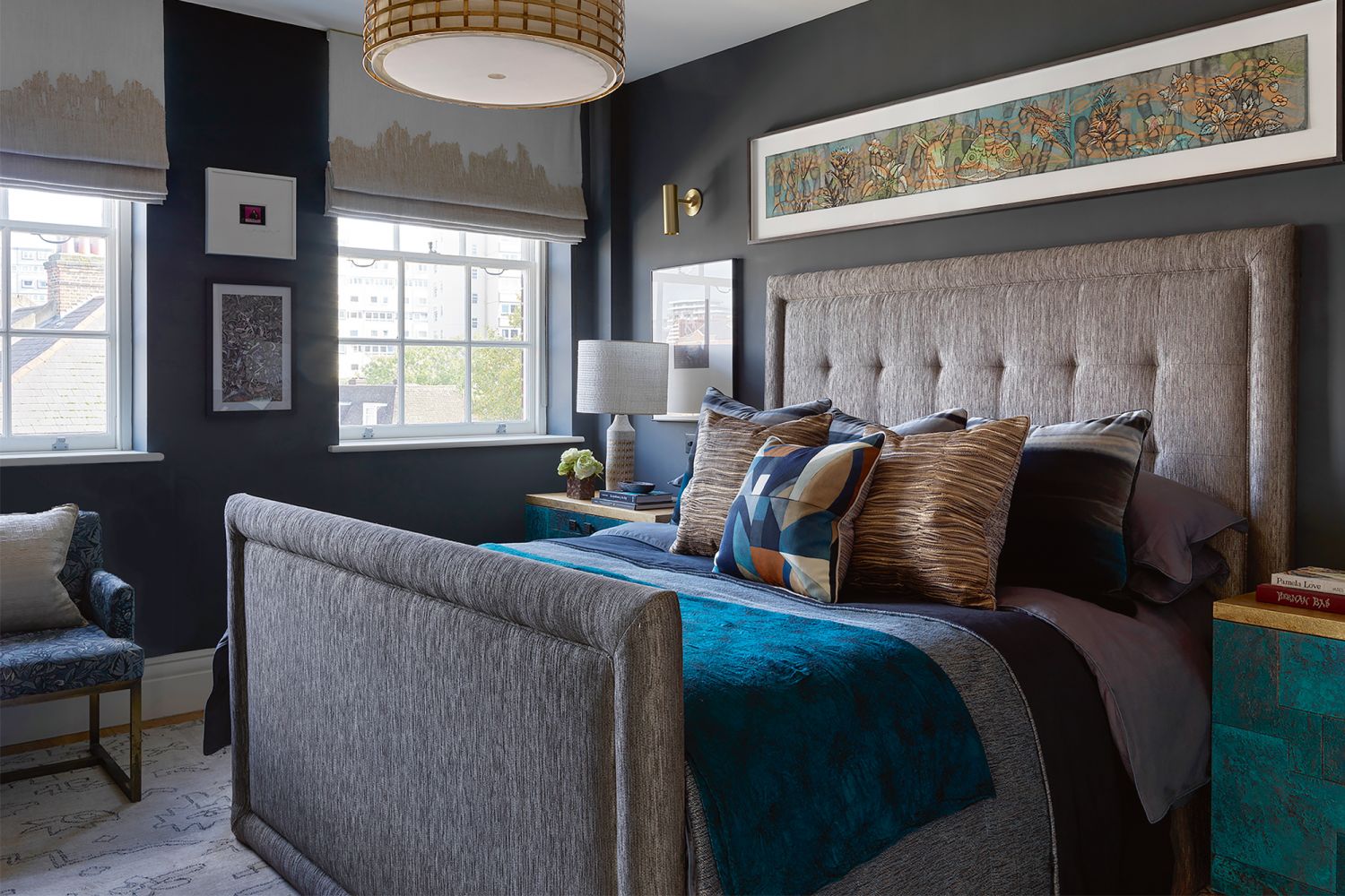 A work by Ibrahim Miranda hangs above the bed in the master bedroom, which also features bedside tables with a stone-like finish in teal