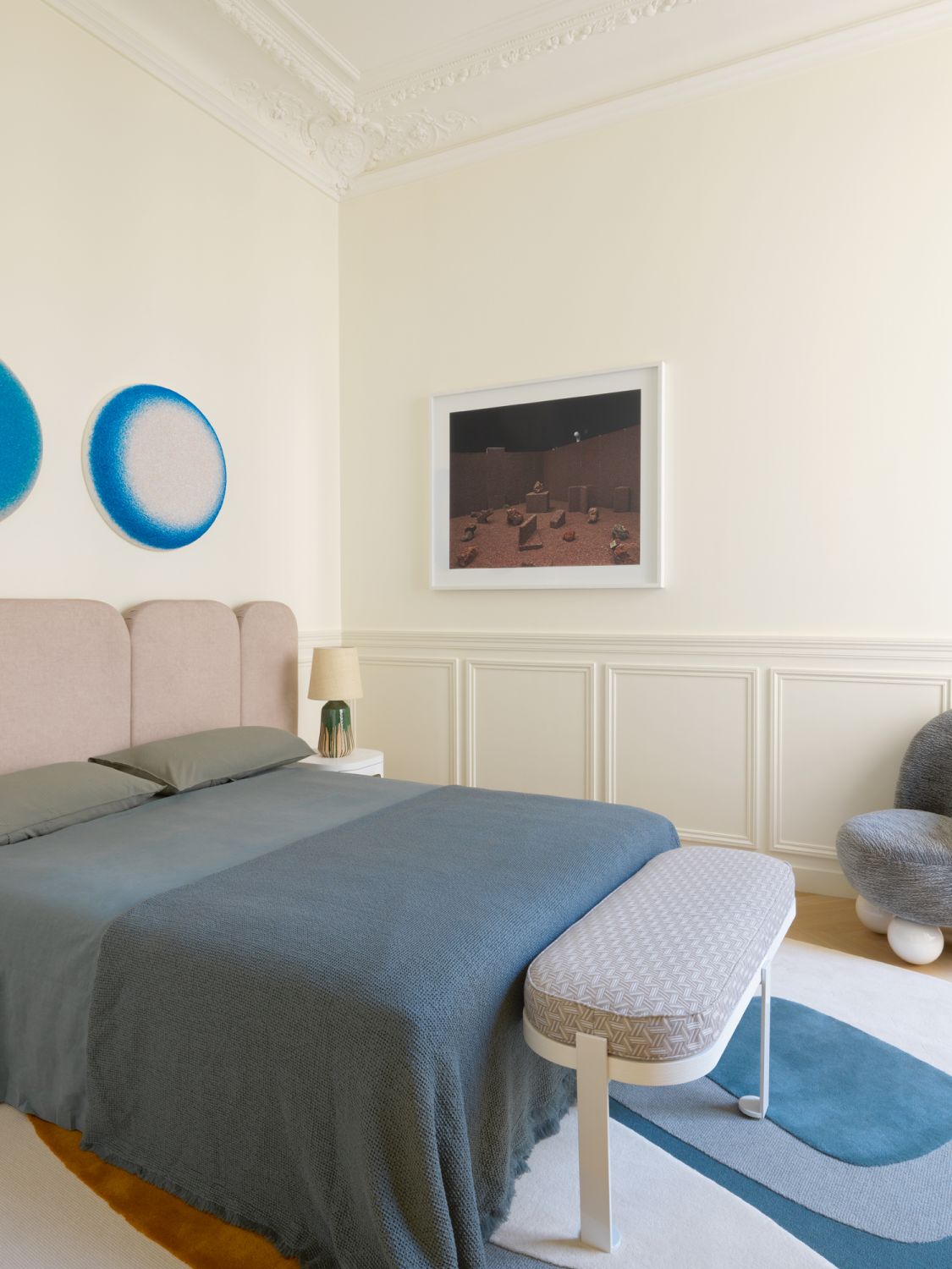 Botanical wallpaper complements the lively mix of toys and pastel-toned furnishings in the child’s bedroom