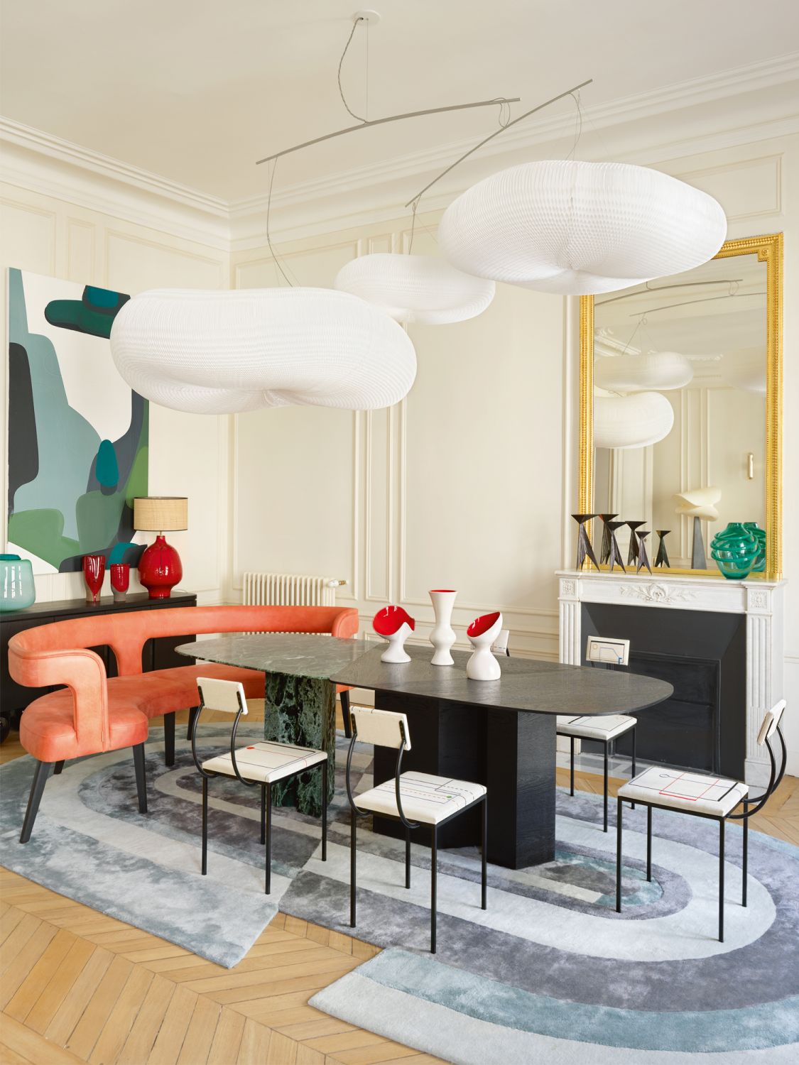Chairs by Pierre Staudenmeyer and Julio Villani, purchased from the Mouvements Modernes Gallery, are paired with a bespoke colourful curved bench in the dining room