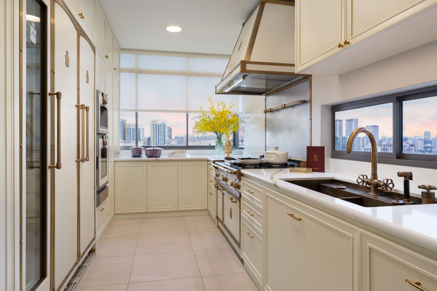 The contemporary kitchen is outfitted with burnished brass appliances from Italian brand Officine Gullo