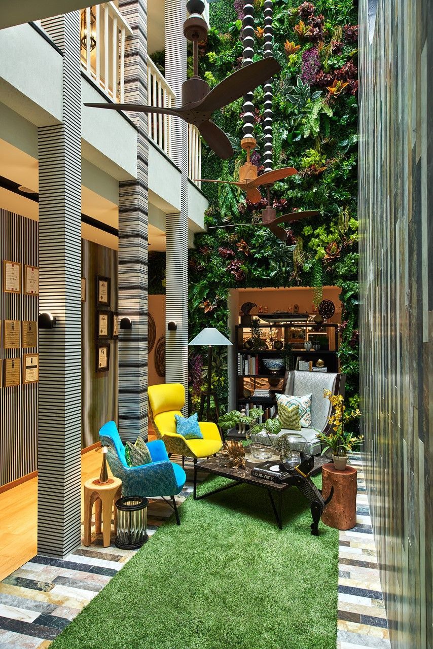 The garden-themed lounge features colourful armchairs and fans from SPIN with decorative beads specially custom-made for this showroom (Photography: Jasper Yu/Jyu Studio)
