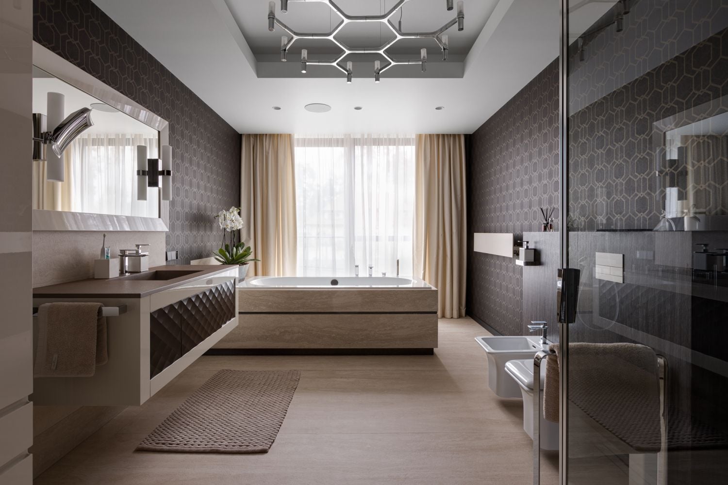 The master bathroom is decked with elegant wallpaper and furniture from MillDue