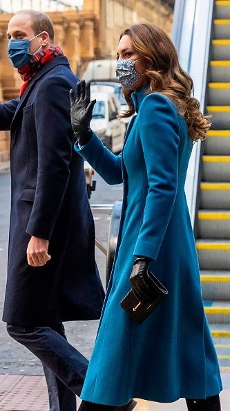 Britain's Prince William, Duke of Cambridge (L) and Britain's Catherine, Duchess of Cambridge (R) wave to well-wishers after disembarking the Royal train as they arrive at Edinburgh Waverley station for a visit to the Scottish Ambulance Service in Newbridge, Edinburgh in Scotland  on December 7, 2020, on their first full day of engagements on their tour of the UK. - During their trip, their Royal Highnesses hope to pay tribute to individuals, organisations and initiatives across the country that have gone a