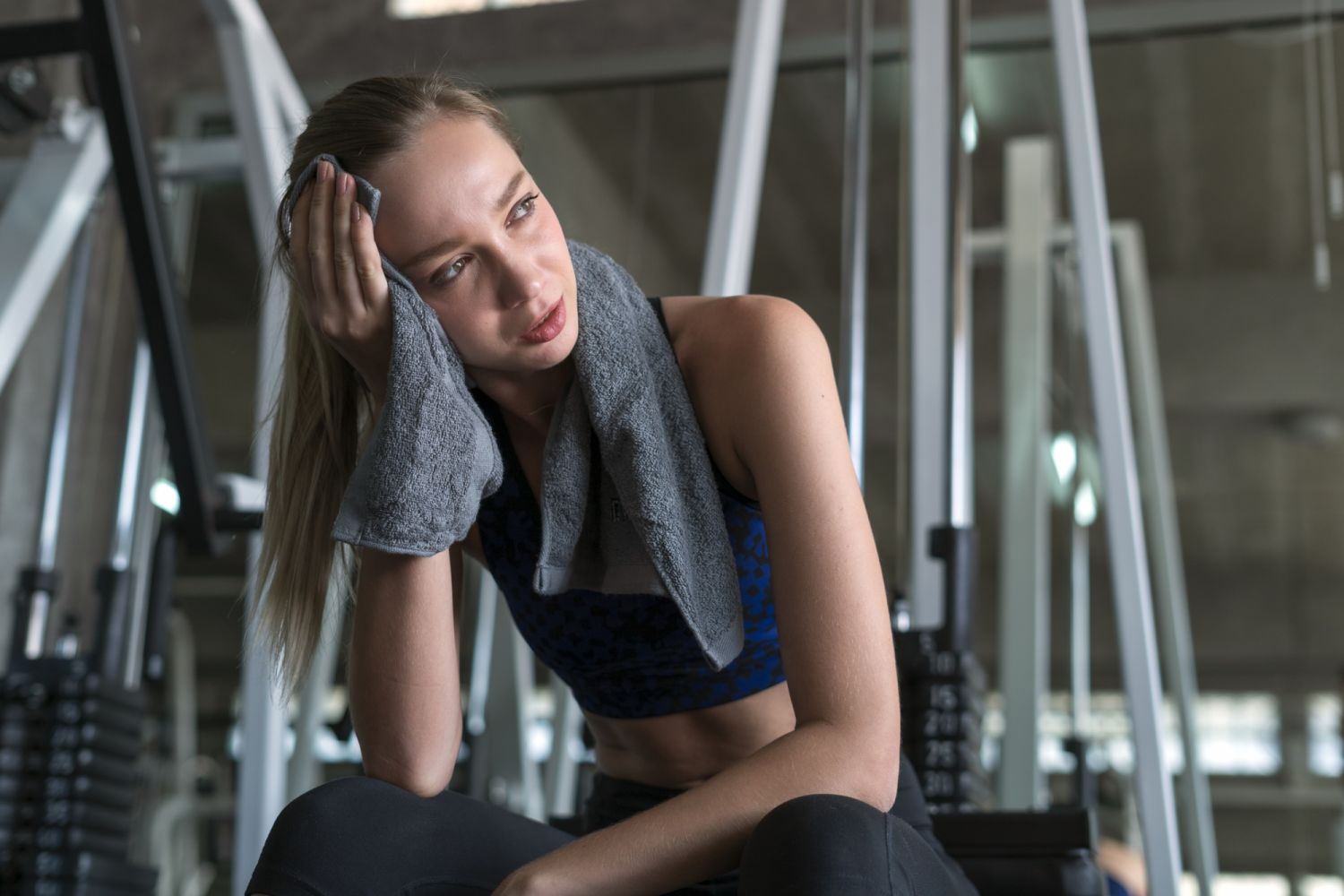 Young woman having a rest after hard training in fitness