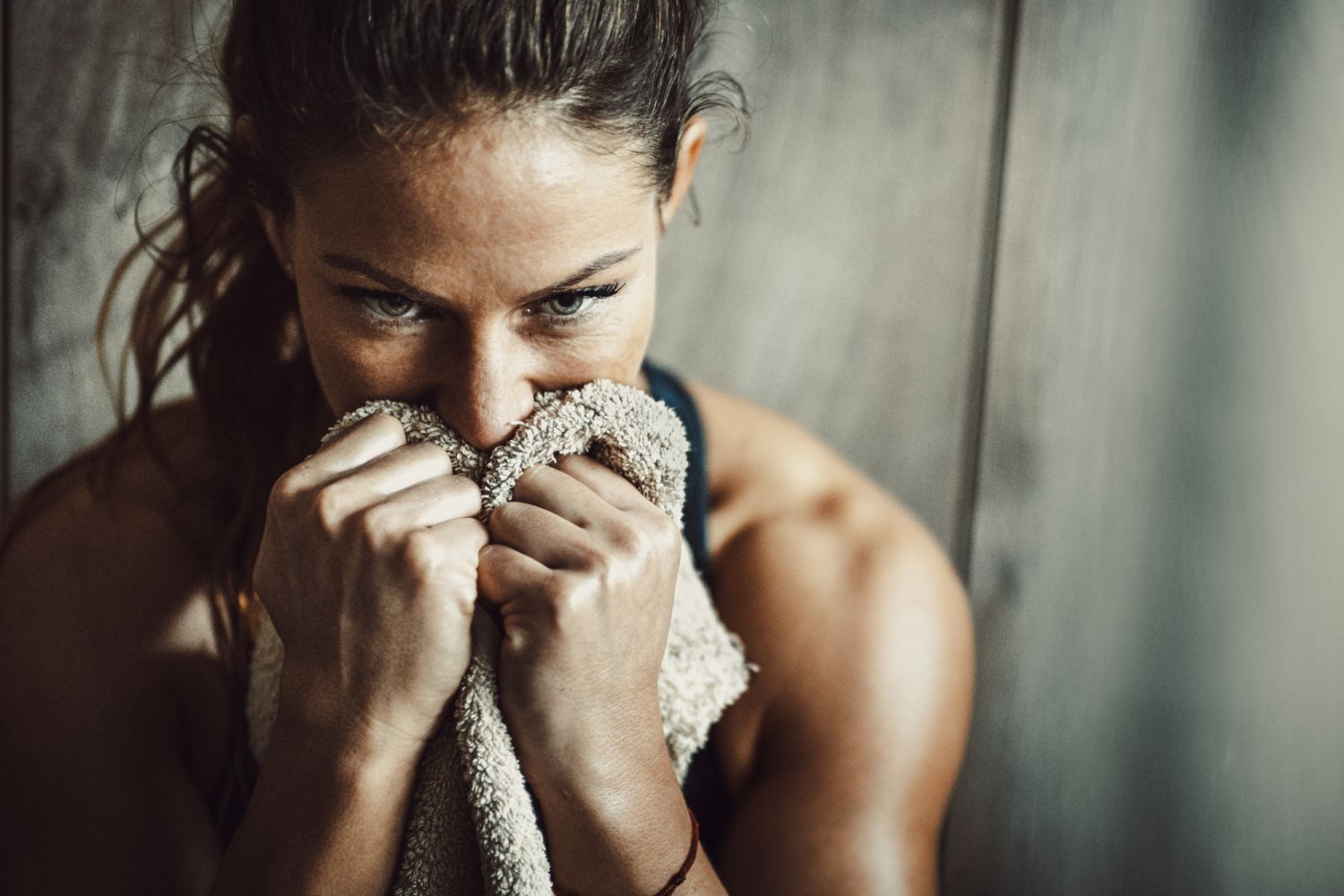 Pensive athletic woman feeling tired after sports training.