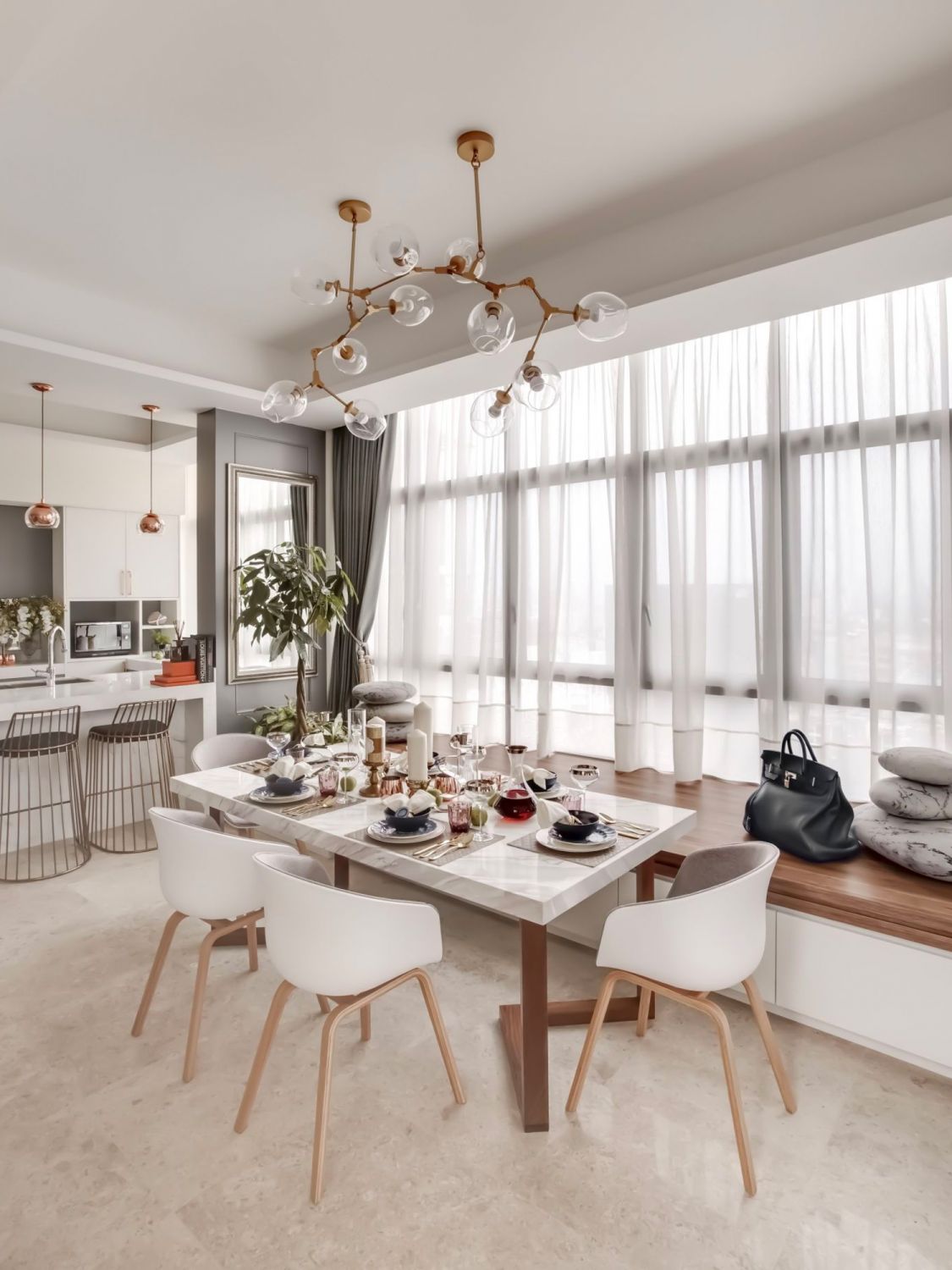 The money tree in this home designed by Prestige Global Designs adds a lively green accent to the space