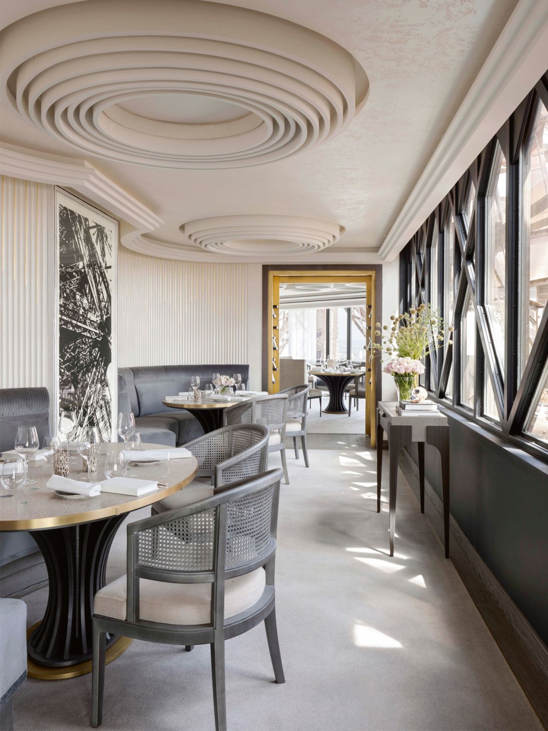 The circular motifs and rounded furnishings in Le Jules Verne stand in contrast to the angular form of the Eiffel Tower