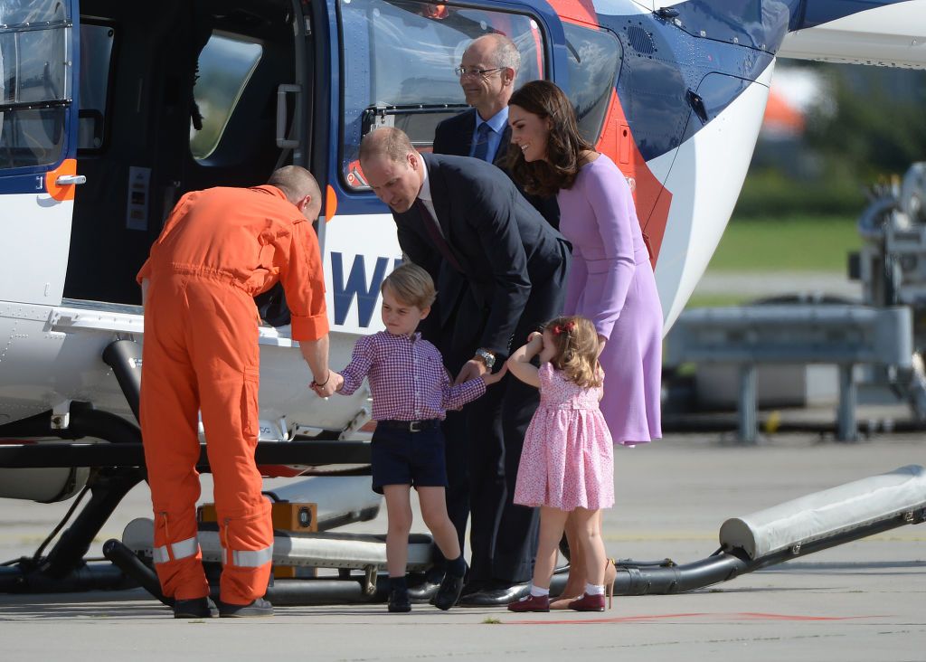 Great Britain's Prince William and Duchess Kate look at an Airbus helicopter with their children George and Charlotte in Hamburg, Germany, 21 July 2017. Hamburg is the last leg of the royal couple's Germany visit. Photo: Christina Sabrowsky/dpa (Photo by Christina Sabrowsky/picture alliance via Getty Images)