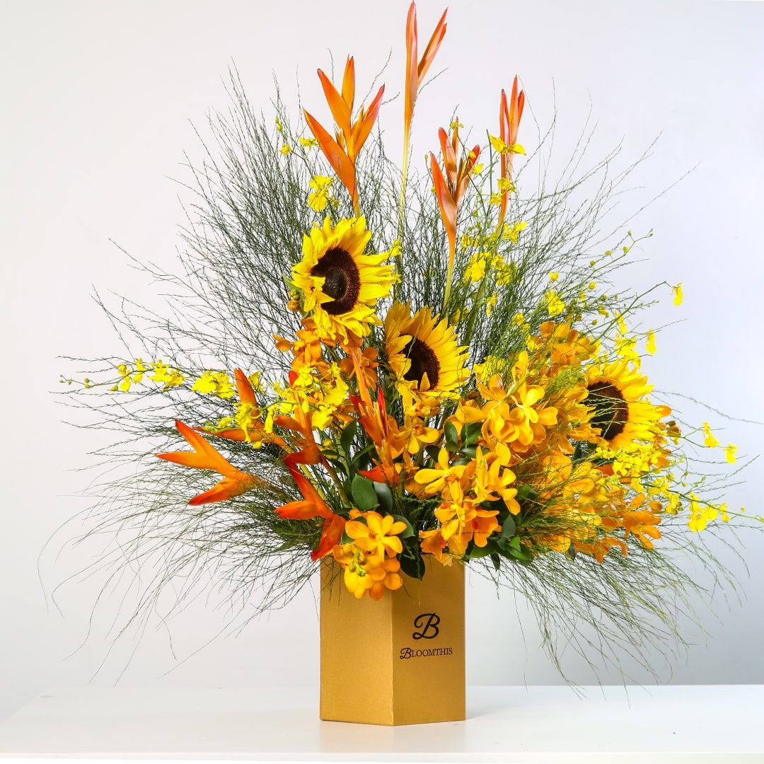 'Charismatic' floral arrangement by BloomThis features sunflowers, heliconias and orchids (Photo: BloomThis)