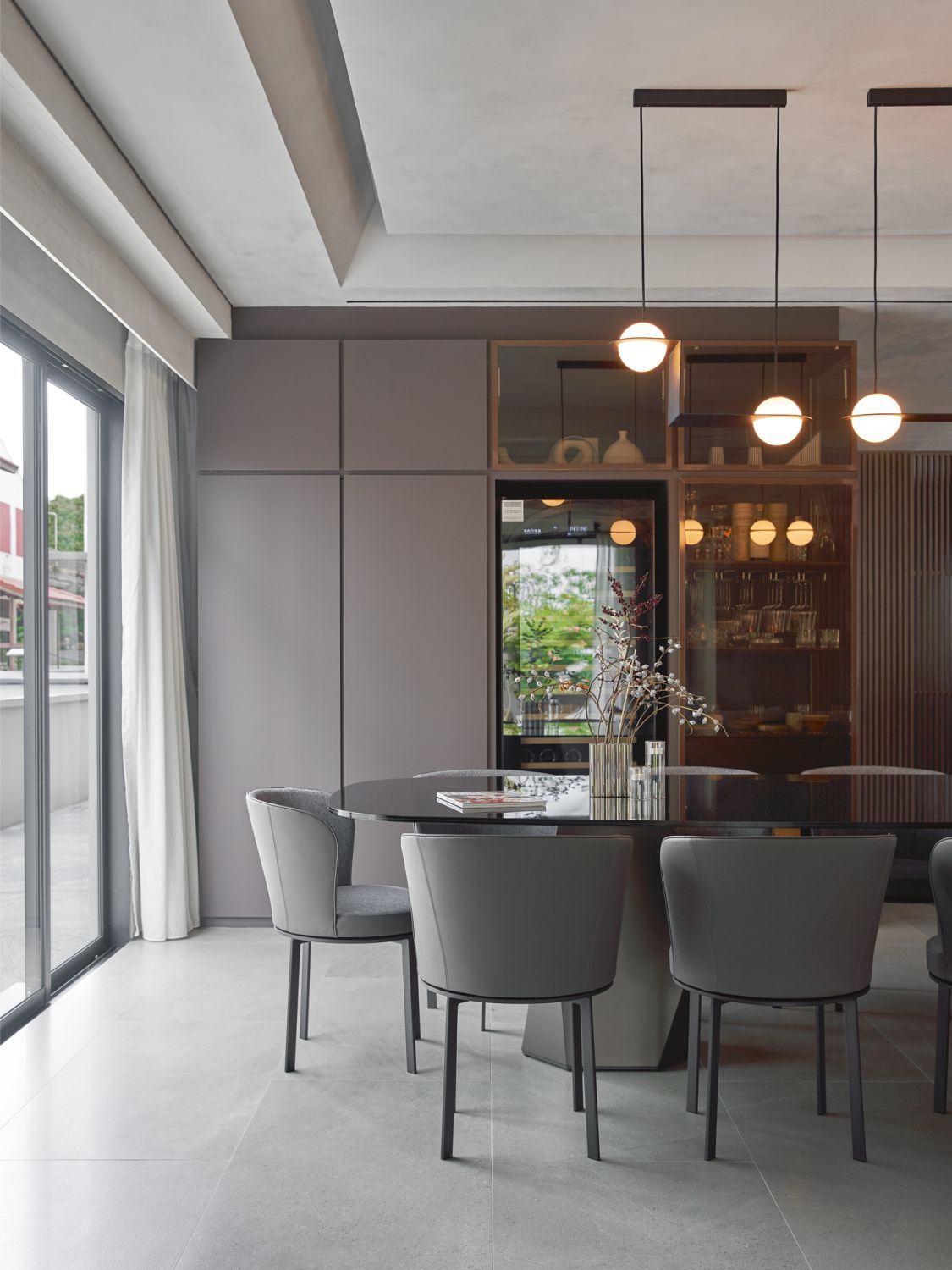Lambert & Fils lamps float elegantly above the 10-seater Deod dining table from Sovet Italia