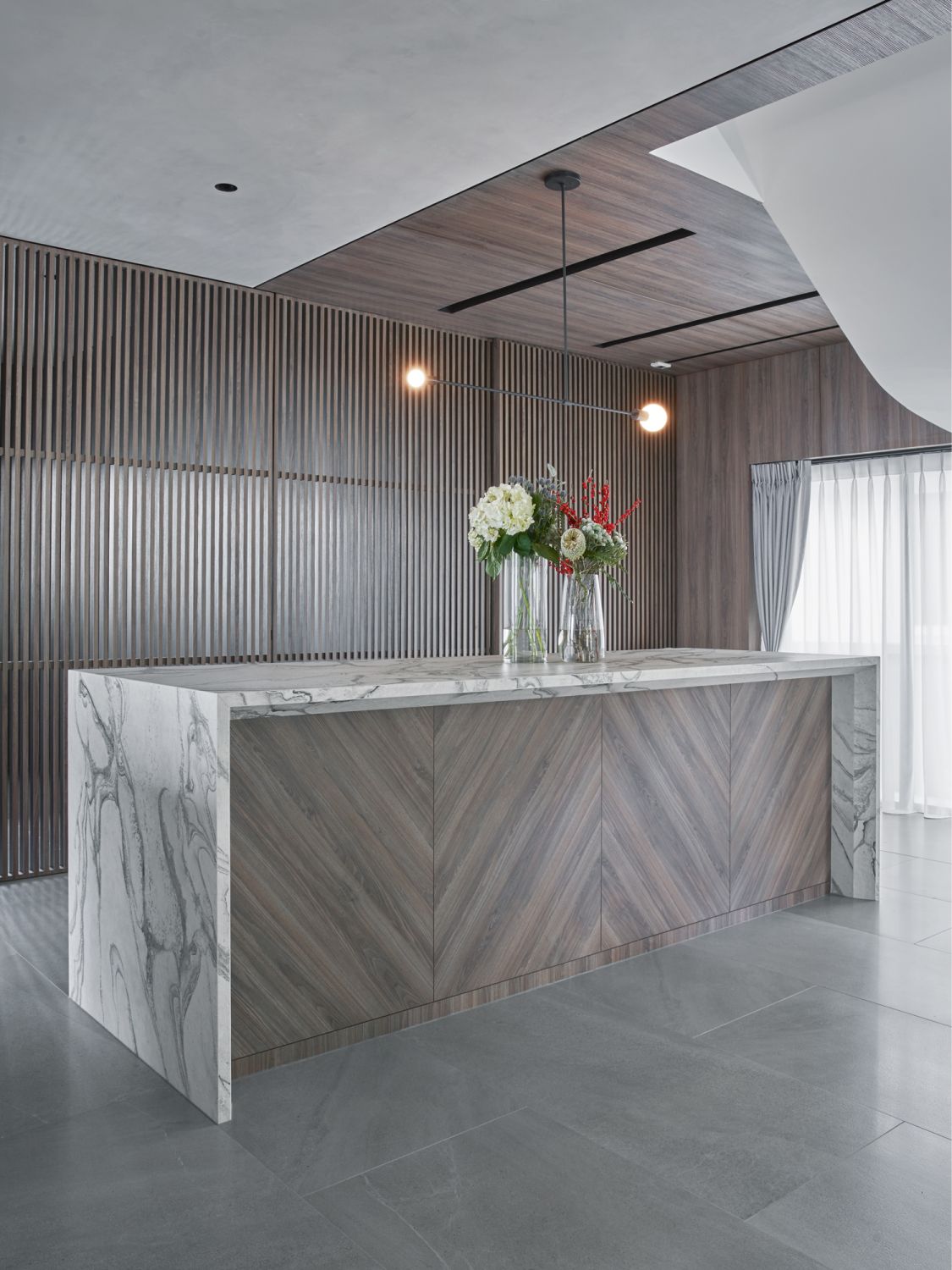 A herringbone pattern on the kitchen island creates visual interest