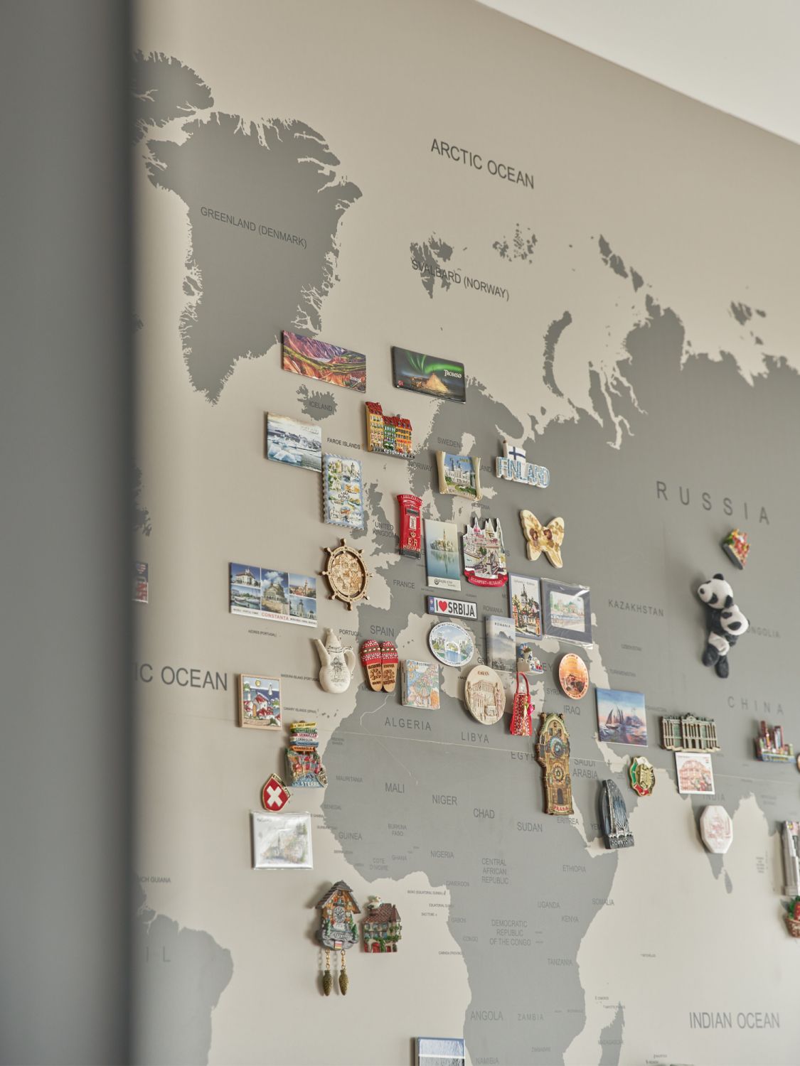 This map of the world in the family room is playfully decorated with the couple’s souvenir magnets