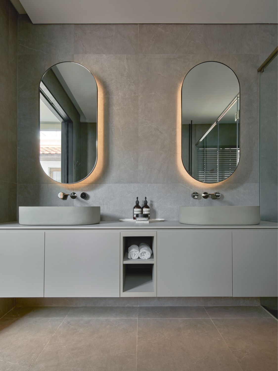 The master bathroom features his-and-hers vanities