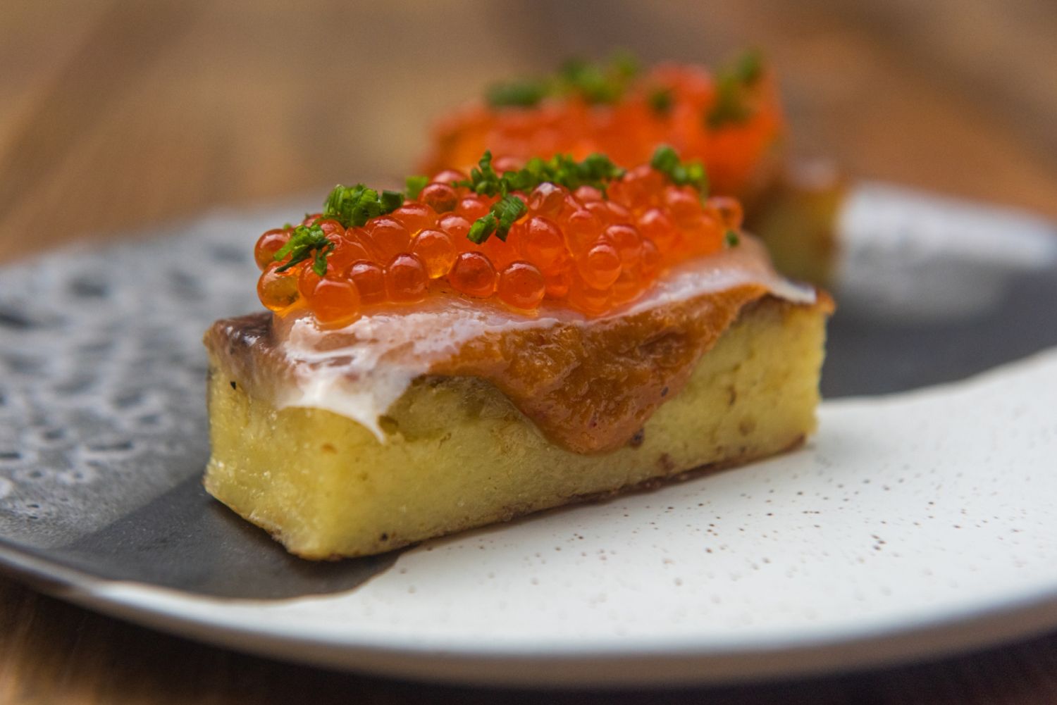 Cassava cake with aligue, mangalista lardo, and ikura (Photo Will Blunt)