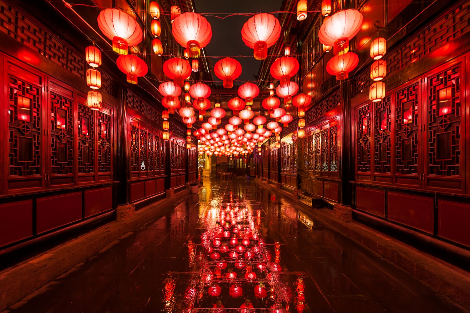 Chengdu - Red chinese lanterns illuminated in Jinli ancient street under the rain for the chinese new year lantern festival.