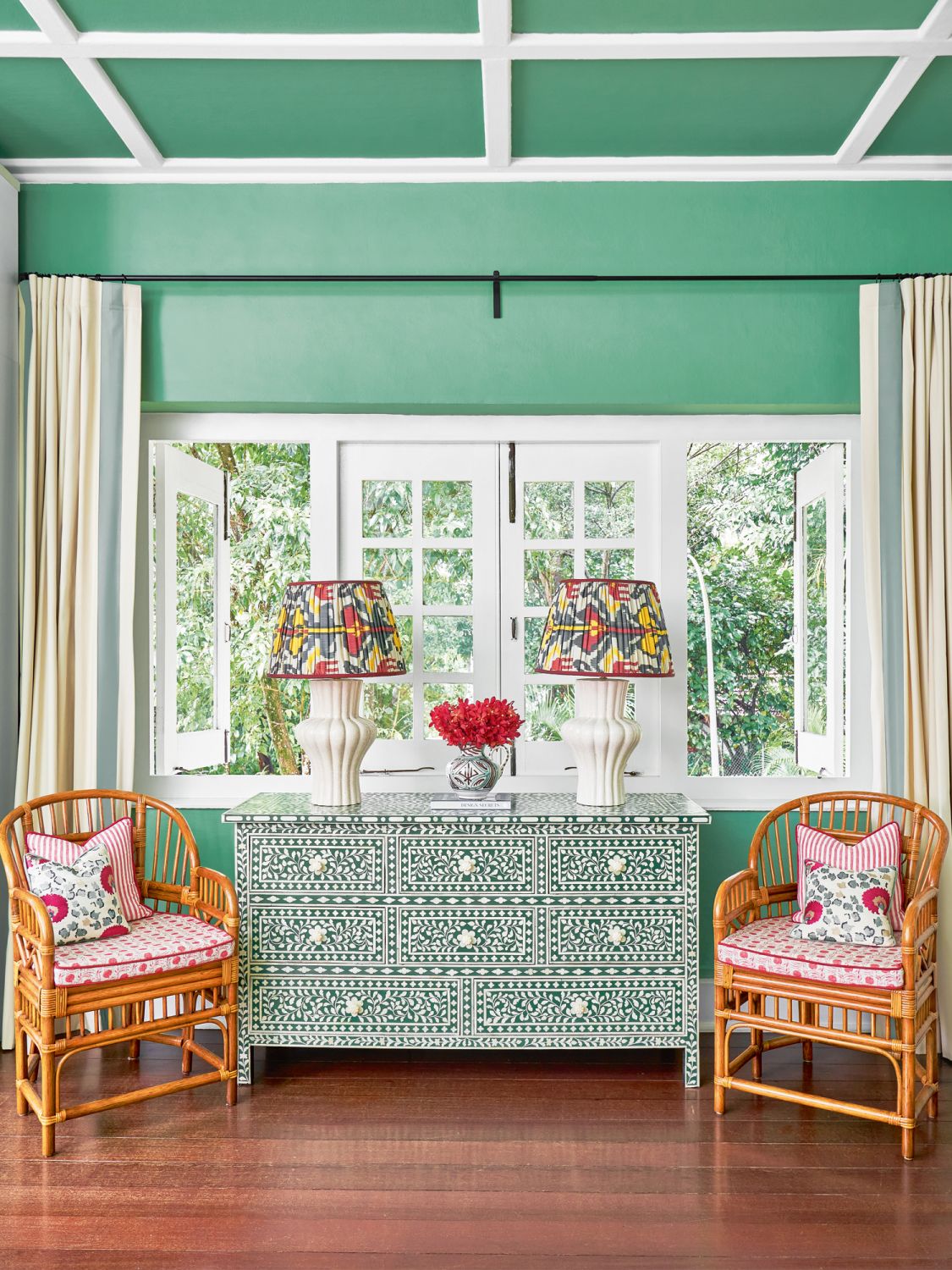 The master bedroom features artisanal pieces such as a green-and-white bone-inlay chest paired with lamps designed by Mor
