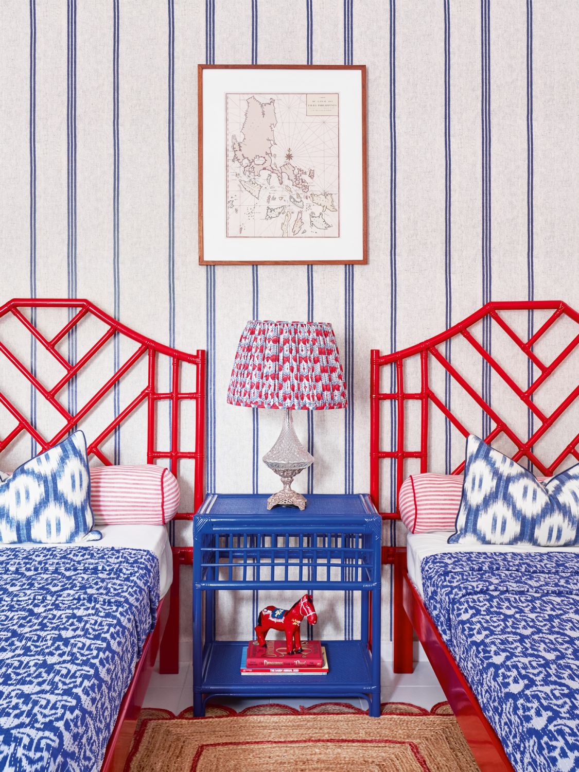 The boys’ nautical-themed bedroom features a pair of rattan bedframes designed by Mora and made by the same artisans who crafted the bedframe in the master bedroom, along with Katalin Stripe wallpaper from Fabrics & Papers in the UK, Mora’s frequent source for wallcovering options