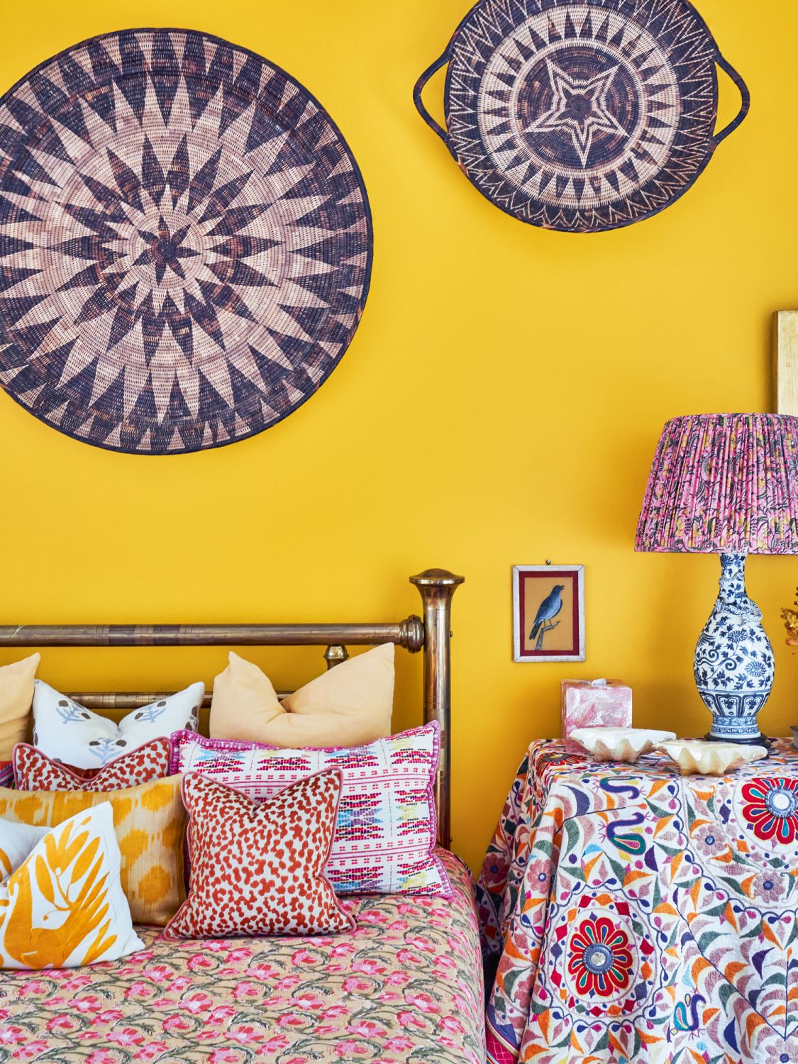 The charming guest room is a visual delight anchored by a copper-plated bed, a family heirloom