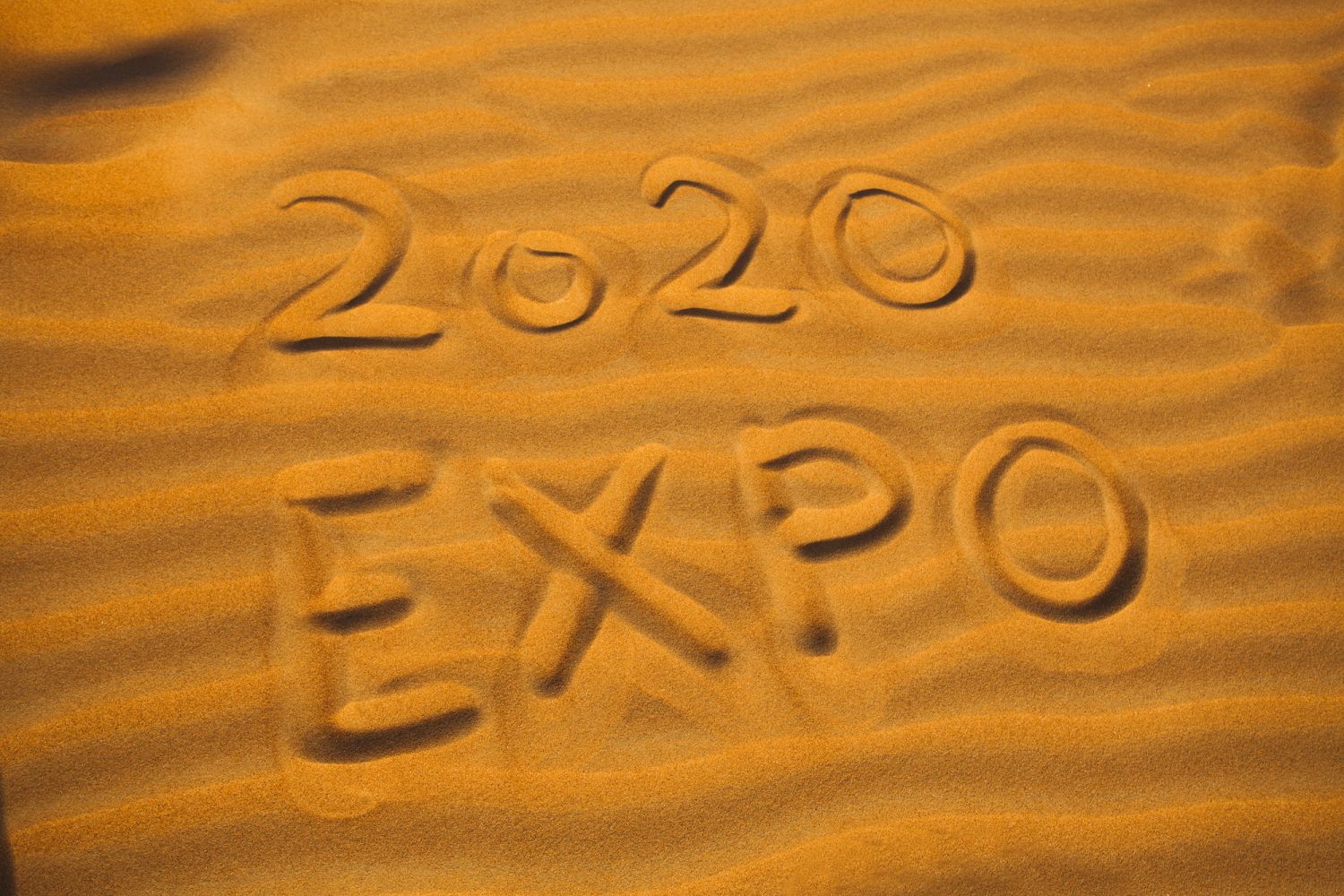 text 2020 expo for Dubai concept written in desert sand