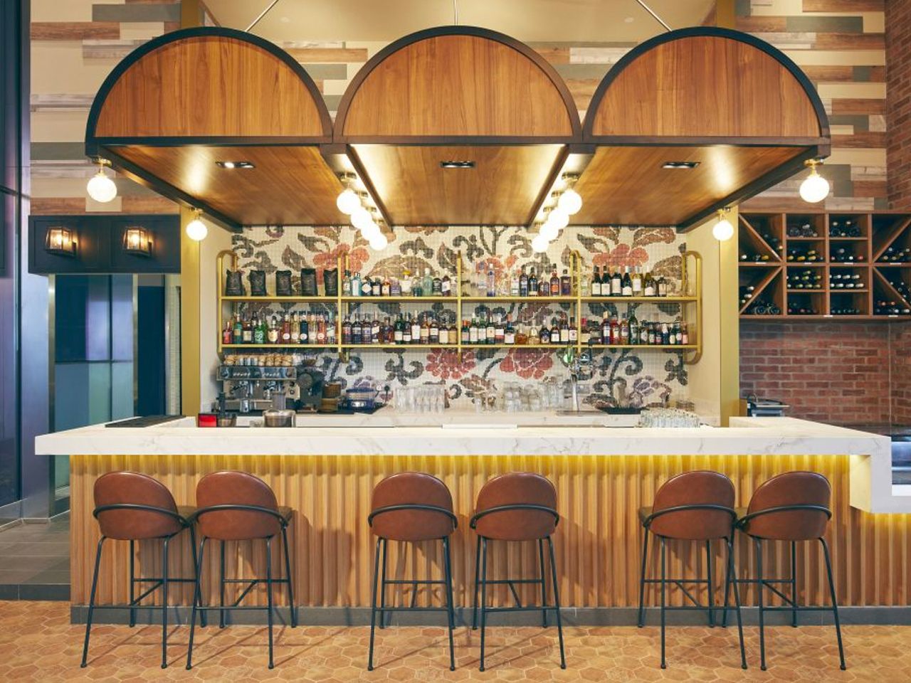 The bar area features a dazzling countertop and unique feature wall mural