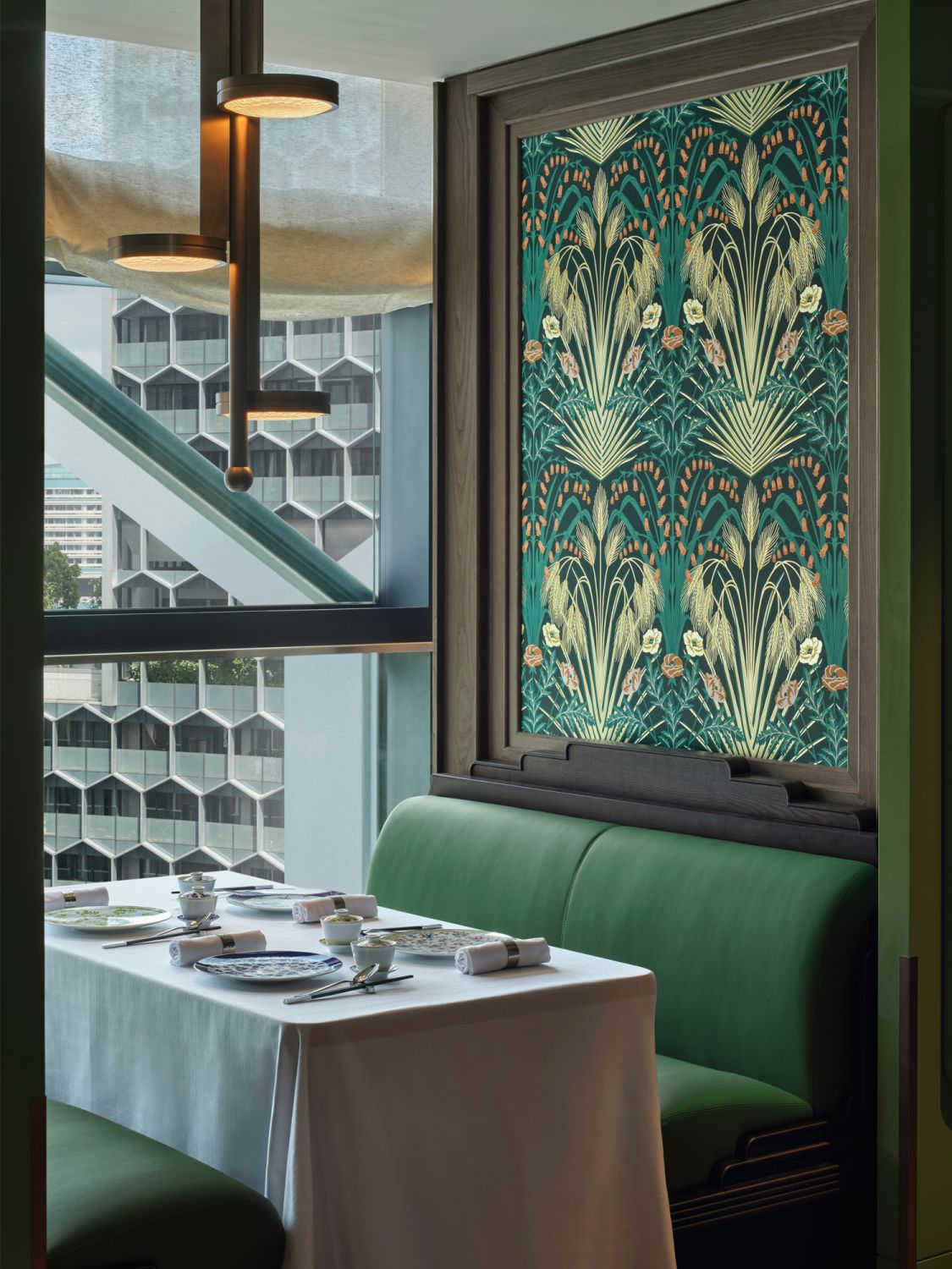 Emerald green hues along with textured velvet accents create an elegant setting for dining