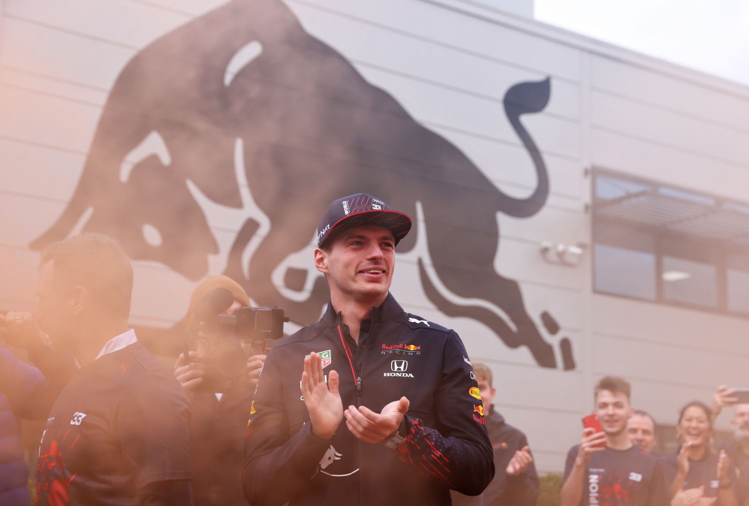 MILTON KEYNES, ENGLAND - DECEMBER 15: 2021 F1 World Drivers Champion Max Verstappen of Netherlands and Red Bull Racing applauds his team as hearrives at Red Bull Racing Factory on December 15, 2021 in Milton Keynes, England. (Photo by Alex Pantling/Getty Images)