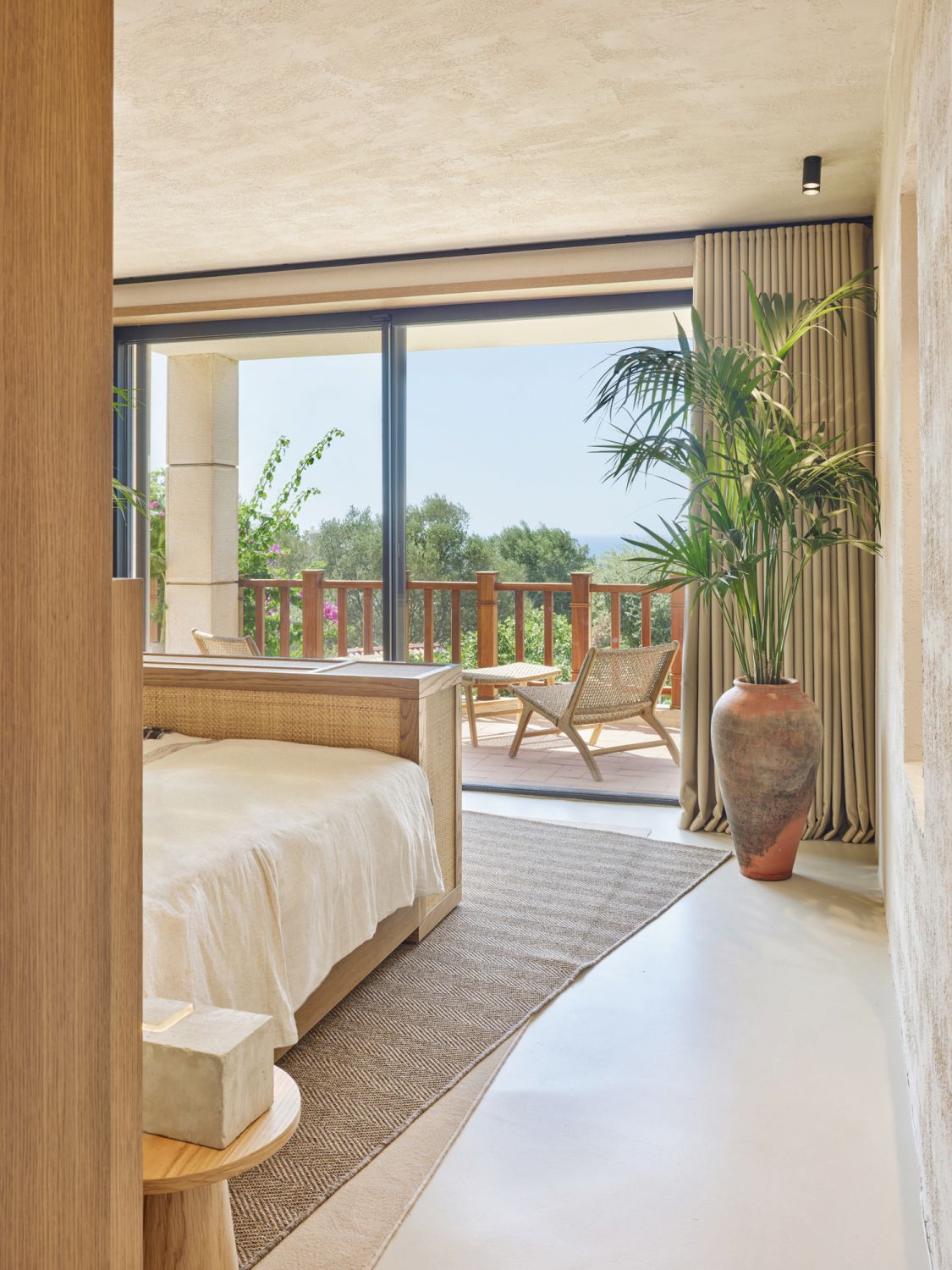 Woven furnishings and textured walls augment the cocooning atmosphere of this bedroom