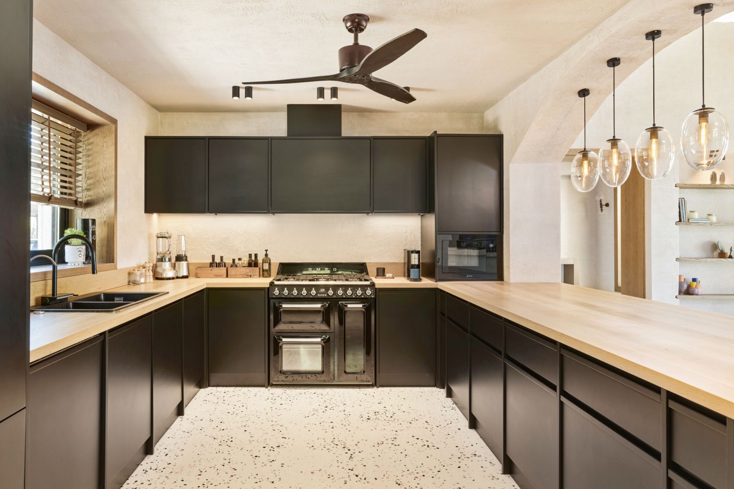 Sleek black cabinetry complements the kitchen’s streamlined fittings and appliances