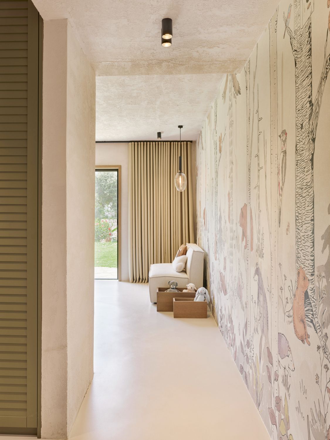 Animal-themed wallpaper evokes a whimsical mood in the child’s room