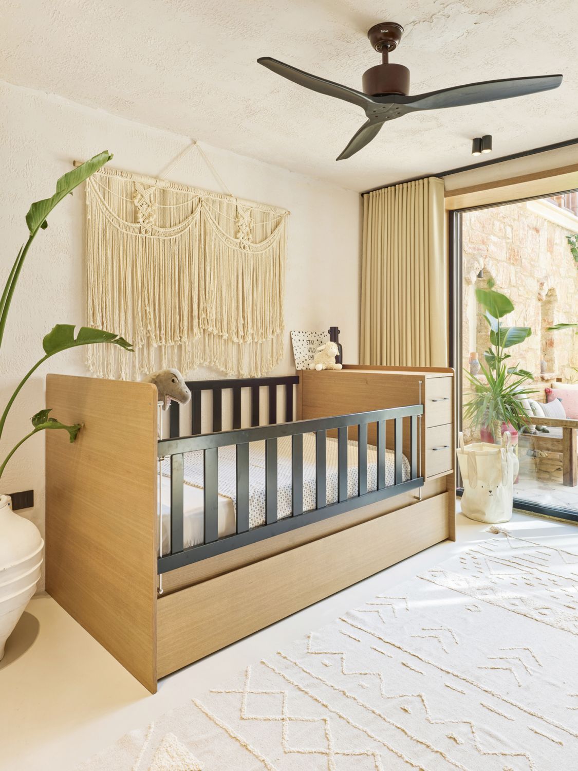 The Kamay Collection crib is paired with a soft rug underfoot to make the nursery extra cosy