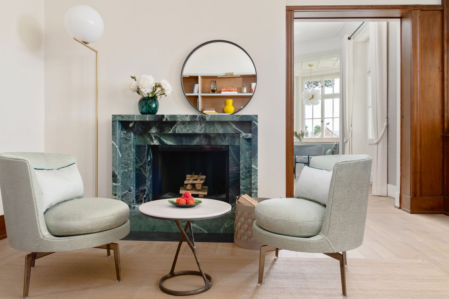 Next to the Flos IC Lights floor lamp is a custom fireplace manufactured by Markus Rüegg Feuer using Verde Alpi marble