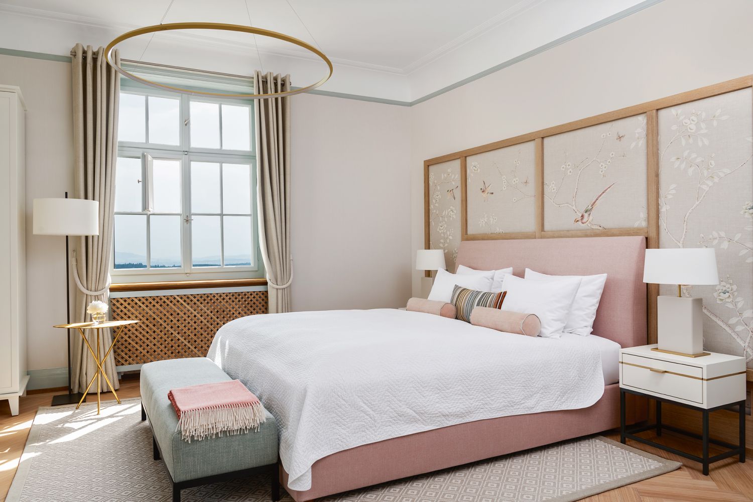 A hand-painted linen wallcovering from De Gournay adds a delicate touch to this bedroom