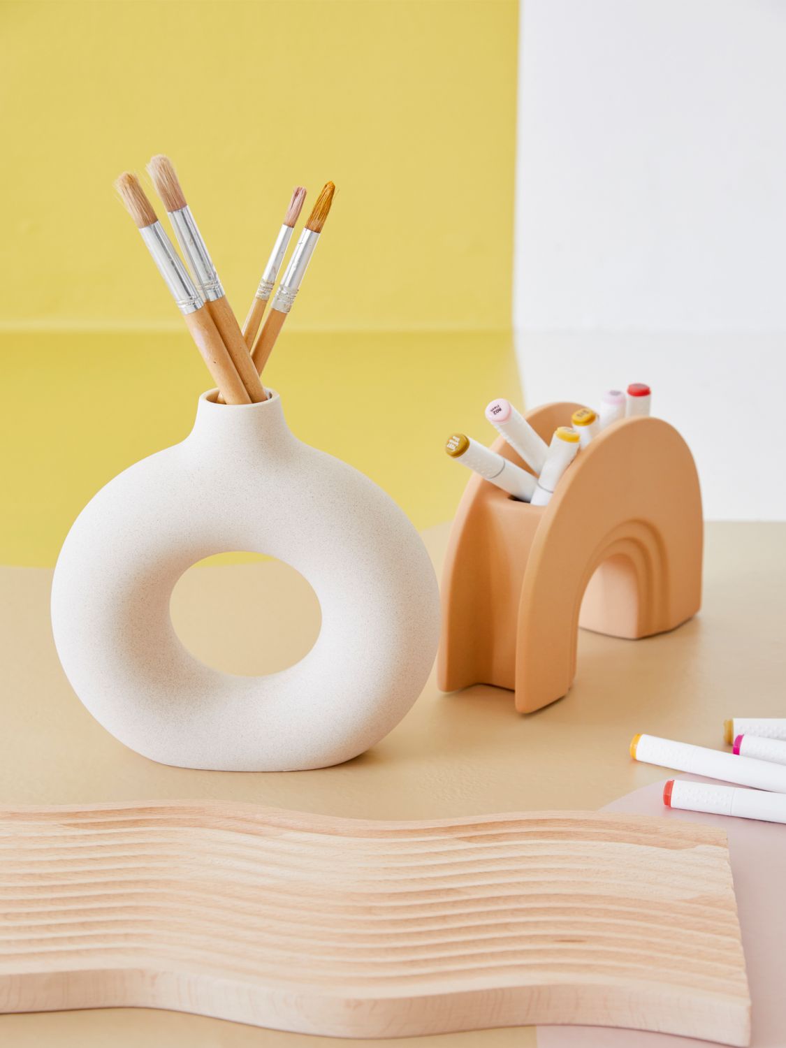 This mix of tall and small vessels, oval triple candleholder and wavy wooden board, are all from Obvi