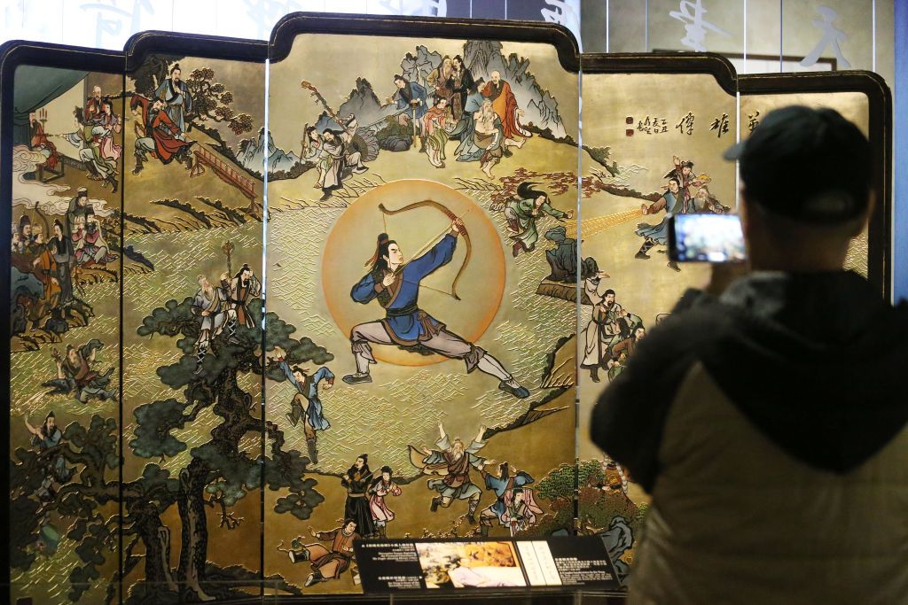 Visitors enjoy the exhibition of Jin Yong Gallery, a permanent exhibition, at the Hong Kong Heritage Museum in Sha Tin. Jin Yong (aka Louis Chia Leung-yung) is one of the renowned Chinese martial arts novel writer in the 20th century. Picture shows an decorative screen depicting the novel characters of The Eagle-shooting Heroes. 01MAR17 SCMP / K. Y. Cheng (Photo by K. Y. Cheng/South China Morning Post via Getty Images)