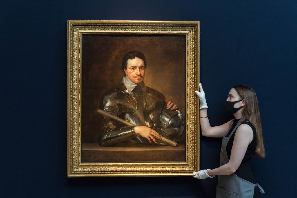 LONDON, UNITED KINGDOM - JULY 05, 2021: A staff member holds 'Portrait of Thomas Wentworth, 1st Earl of Strafford (1593-1641), half-length, in armour' by Sir Anthony van Dyck (1599-1641), estimate £3,000,000-5,000,000 during a photo call for Classic Week at Christie's auction house, a marquee series of nine auctions which feature works of art from antiquity to the 20th century on July 05, 2021 in London, England. (Photo credit should read Wiktor Szymanowicz/Barcroft Media via Getty Images)
