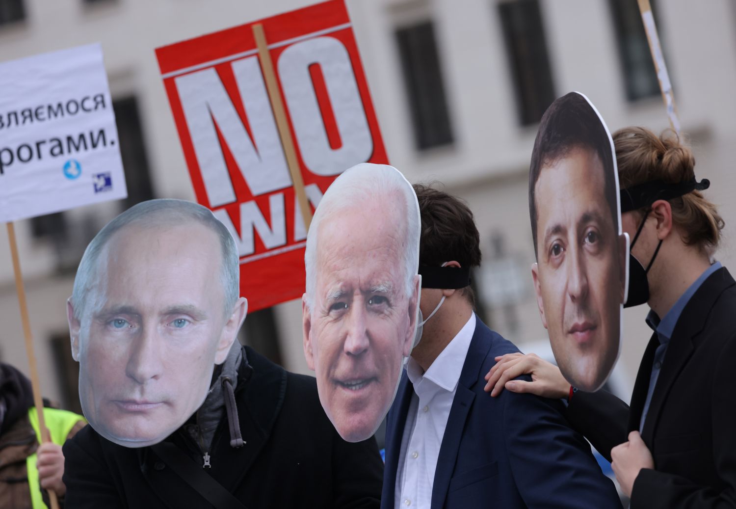 BERLIN, GERMANY - FEBRUARY 09: Protesters dressed as Russian President Vladimir Putin (L), U.S. President Joe Biden (C) and Ukrainian President Volodymyr Zelensky attend a small rally to demand a diplomatic solution to the current threat of war in Ukraine on February 09, 2022 in Berlin, Germany. Russia has amassed thousands of troops along its border to Ukraine, causing international fears of a possibly imminent military invasion. (Photo by Sean Gallup/Getty Images)