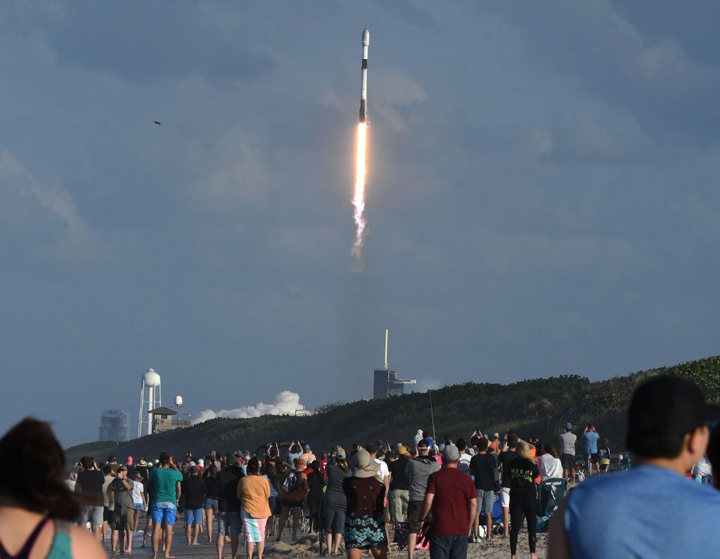 CAPE CANAVERAL, FLORIDA, UNITED STATES - 2021/05/15: People watch from Playalinda Beach at Canaveral National Seashore as a SpaceX Falcon 9 rocket carrying the 28th batch of satellites for SpaceXs Starlink broadband network launches from pad 39A at the Kennedy Space Center. In addition to 52 Starlink satellites, the rocket is also carrying rideshare payloads for Capella Space and Tyvak Nano-Satellite Systems. (Photo by Paul Hennessy/SOPA Images/LightRocket via Getty Images)